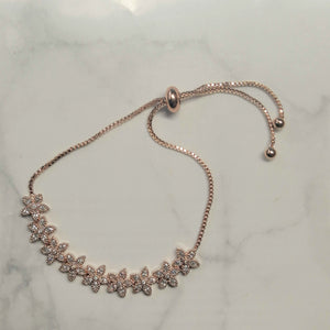 PR648 PULSERA ROSA AJUST FLORECITAS